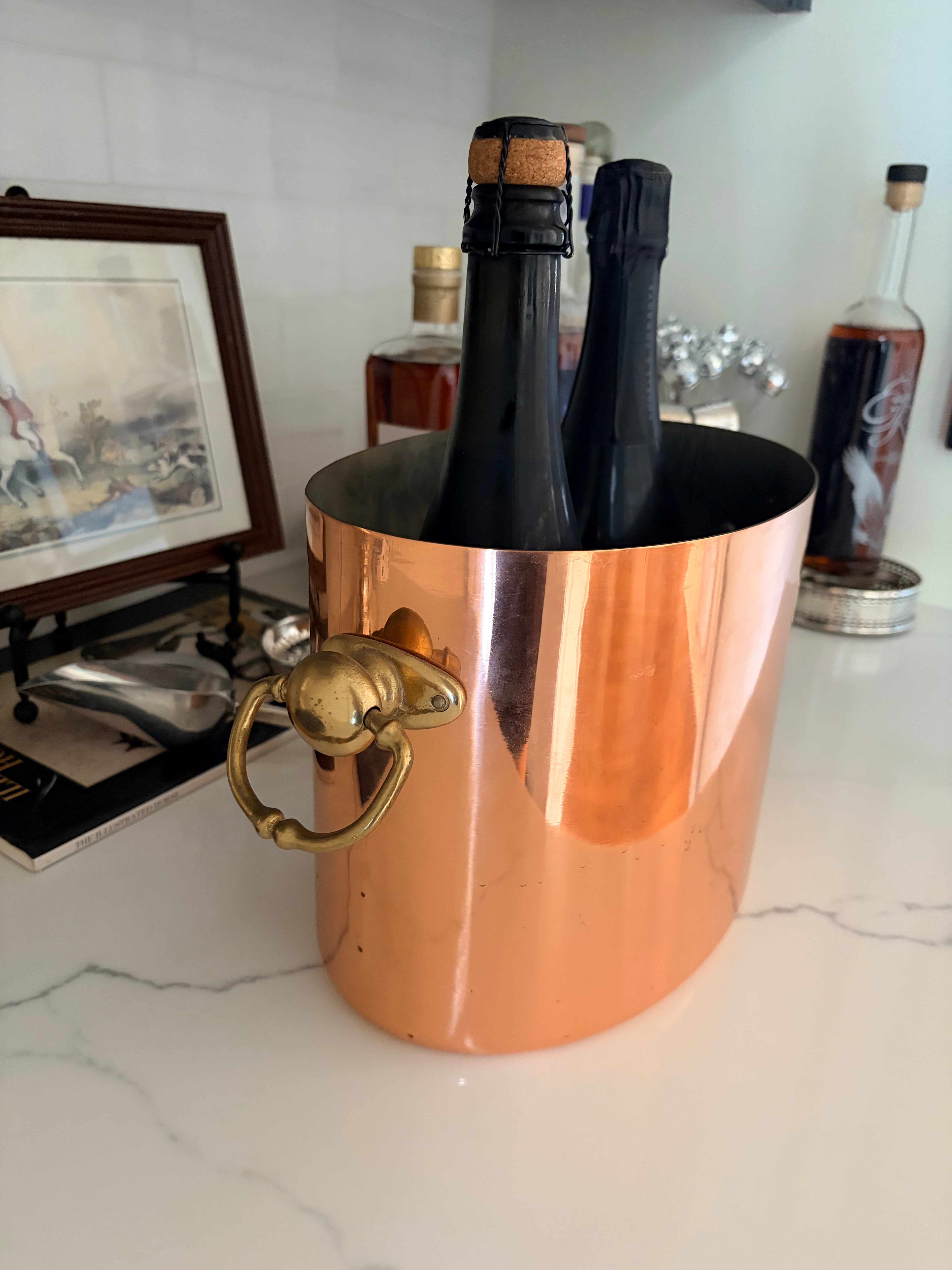 Copper champagne bucket viewed from above with the two-bottle divider
