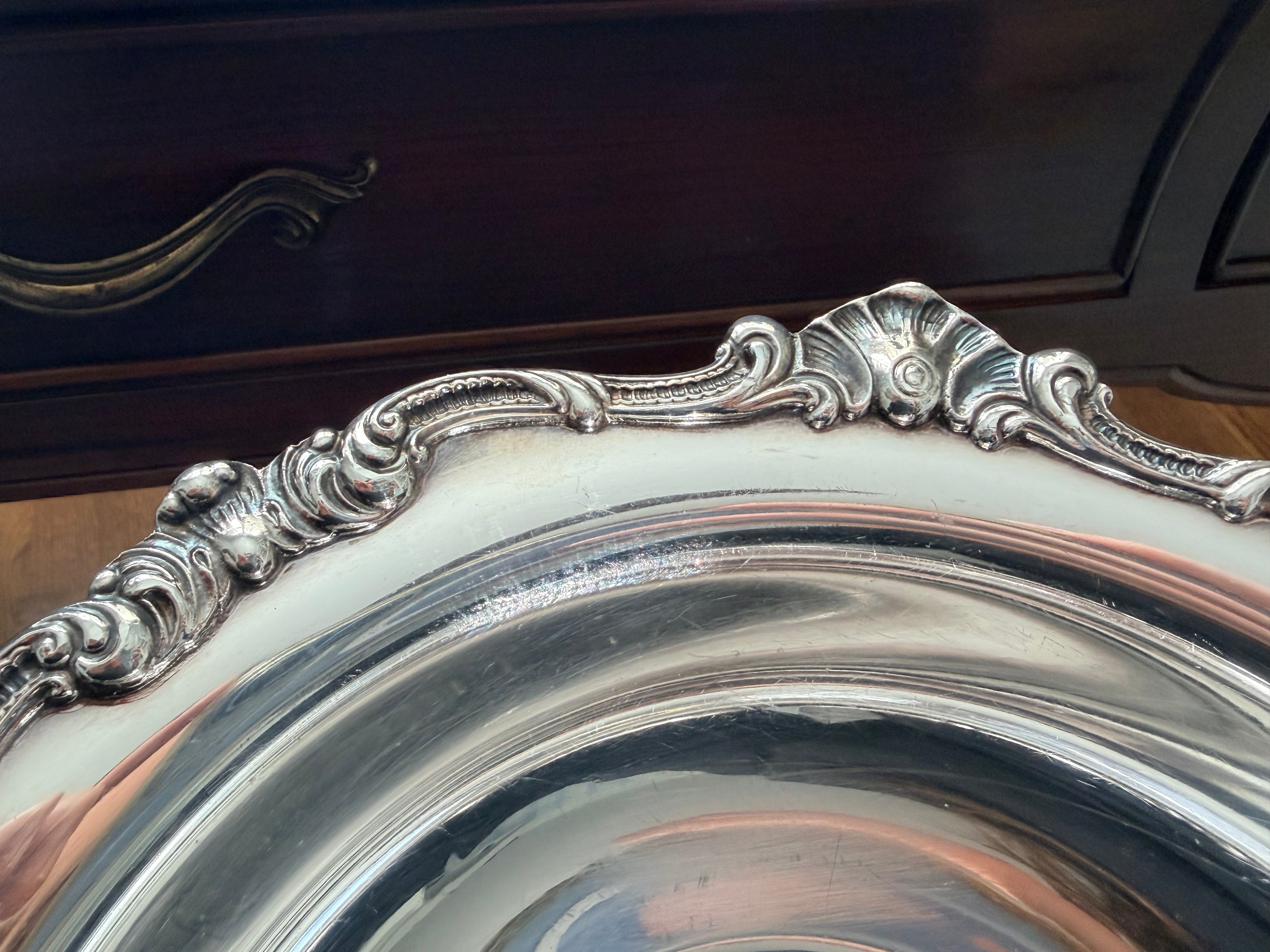 Detail of the Gorham Strasbourg rim showing the scrolling rococo shell and leaf pattern